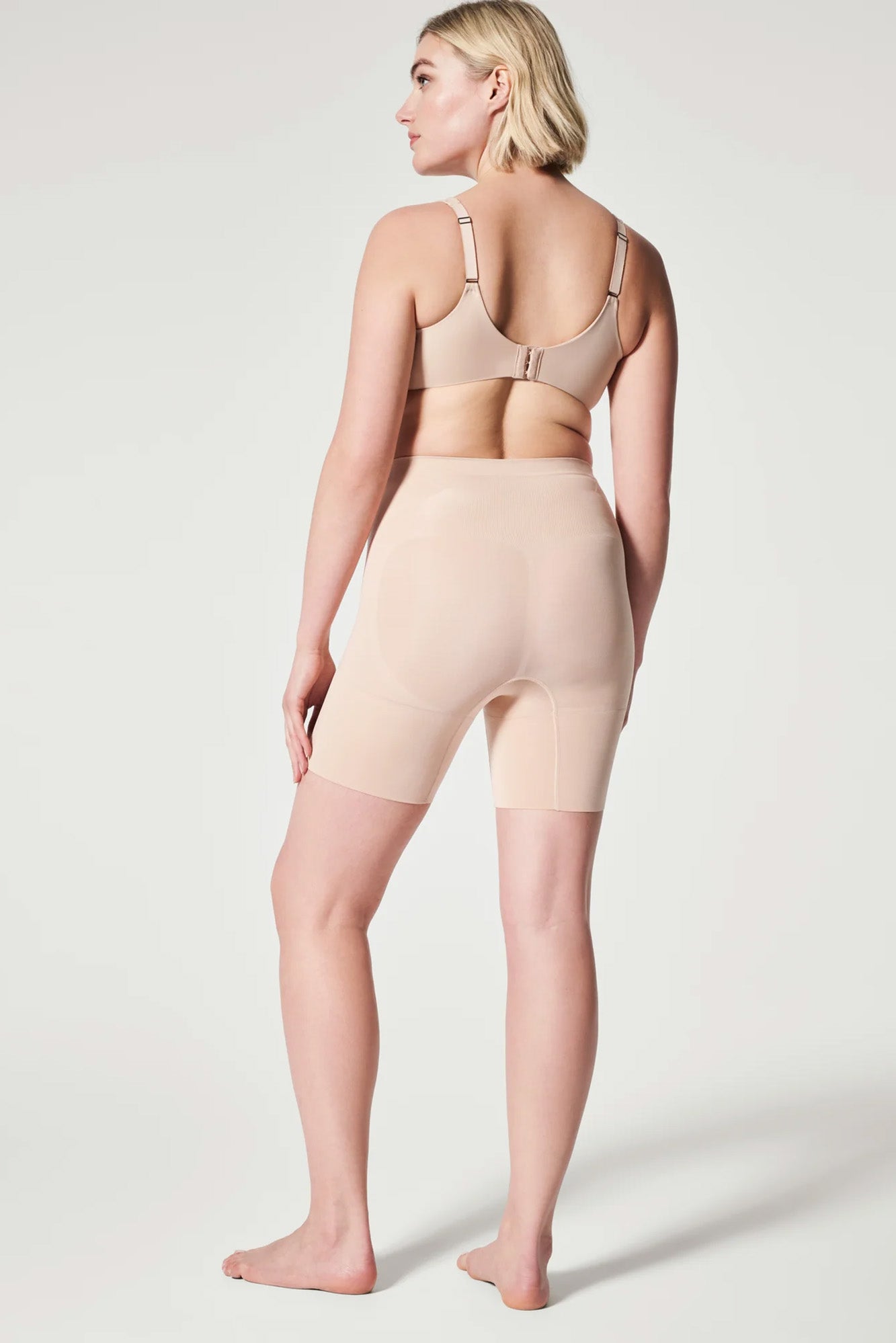 The Oncore Mid-Thigh Short By Spanx In Soft Nude - GINIA